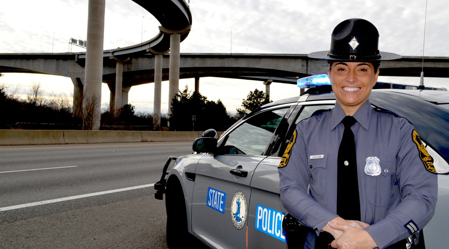 Virginia state police officer standing by patrol car